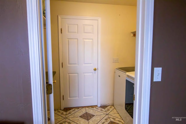 laundry room with light tile patterned flooring and washer and dryer