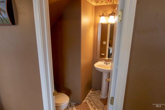 bathroom featuring tile patterned flooring, sink, and toilet