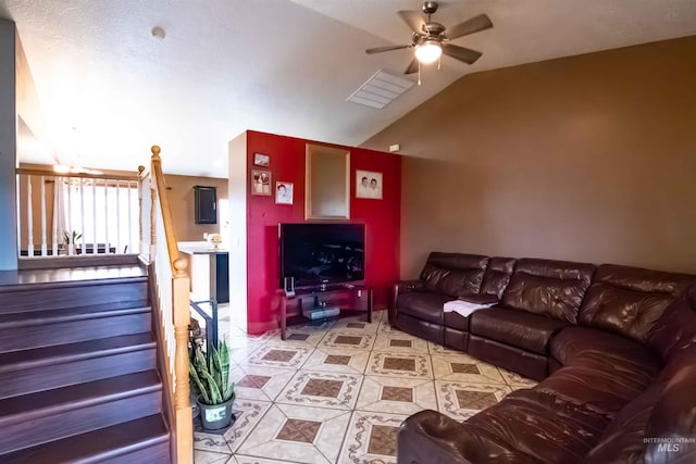 tiled living room with ceiling fan and lofted ceiling