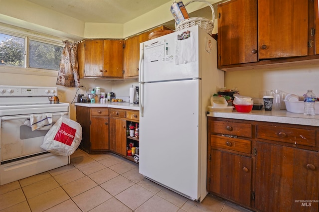 kitchen with white appliances and light tile patterned floors