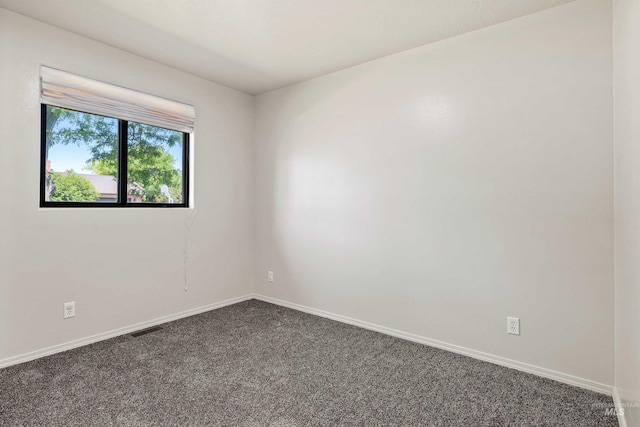 1131 Aztec Dr, Twin Falls, ID 83301 - spare room featuring dark colored carpet and baseboards