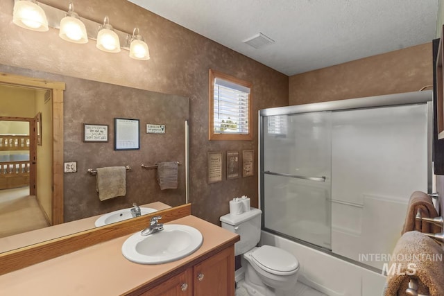 13098 Hillhouse Loop, Donnelly, ID 83615 - full bathroom with vanity, toilet, and bath / shower combo with glass door