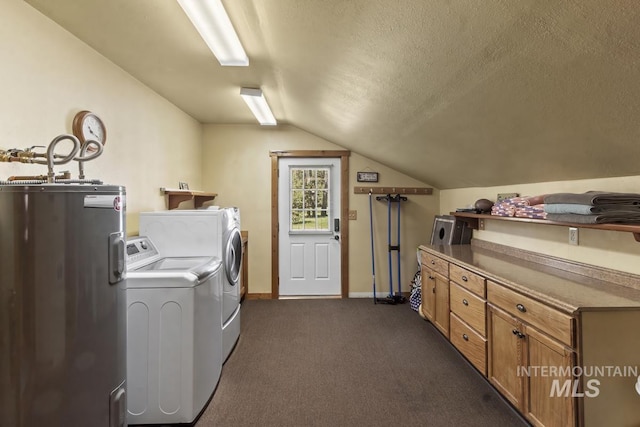 13098 Hillhouse Loop, Donnelly, ID 83615 - laundry area featuring washing machine and dryer, water heater, baseboards, cabinet space, and dark carpet