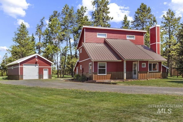 13098 Hillhouse Loop, Donnelly, ID 83615 - view of front of property featuring a garage, an outdoor structure, a front yard, a chimney, and driveway