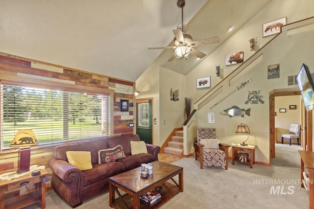 13098 Hillhouse Loop, Donnelly, ID 83615 - living area with stairs, ceiling fan, light colored carpet, high vaulted ceiling, and wood walls