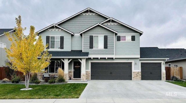 craftsman-style house featuring a front yard and a garage