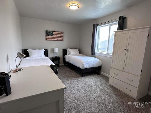 carpeted bedroom with a textured ceiling