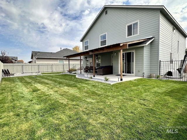 rear view of property with a yard and a patio area