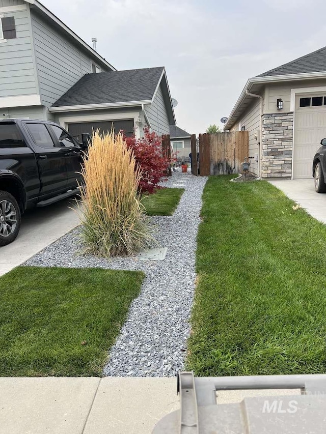 view of home's exterior with a yard and a garage