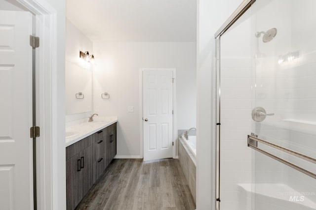 15414 Ivybridge Way, Nampa, ID 83651 - full bath with a shower stall, wood finished floors, double vanity, and a sink
