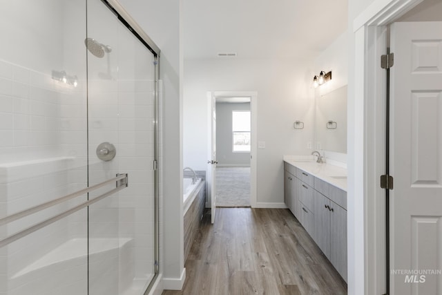 15414 Ivybridge Way, Nampa, ID 83651 - full bath featuring a garden tub, a shower stall, wood finished floors, a sink, and double vanity
