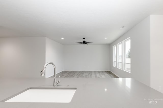 15414 Ivybridge Way, Nampa, ID 83651 - unfurnished living room featuring ceiling fan, visible vents, recessed lighting, a sink, and light wood finished floors