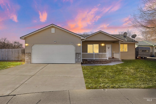 ranch-style house with covered porch, a garage, fence, concrete driveway, and a front lawn