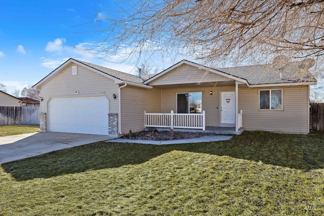 ranch-style home featuring a garage, driveway, fence, and a front yard