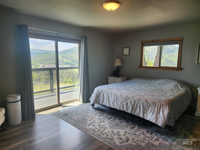 131 Beaver Nob Dr, Kamiah, ID 83536 - bedroom with access to exterior, multiple windows, and wood finished floors