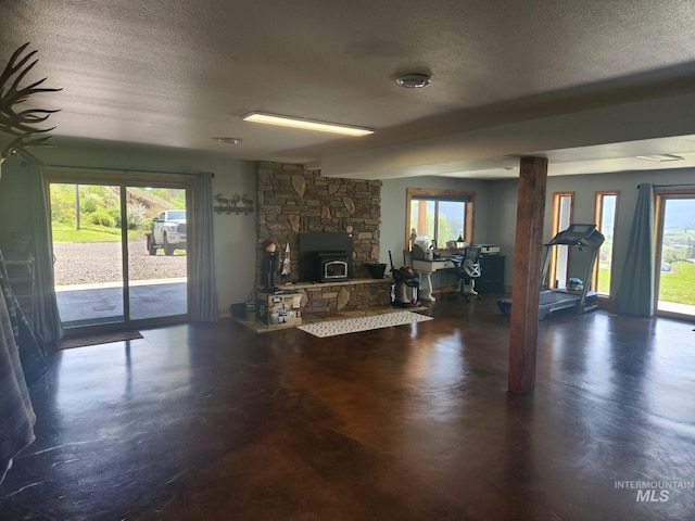 131 Beaver Nob Dr, Kamiah, ID 83536 - living room with a textured ceiling, finished concrete floors, and a fireplace