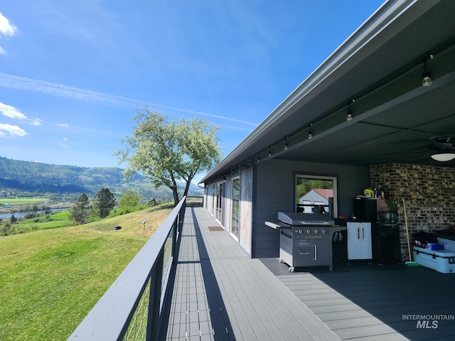 131 Beaver Nob Dr, Kamiah, ID 83536 - wooden deck with area for grilling, a yard, and ceiling fan
