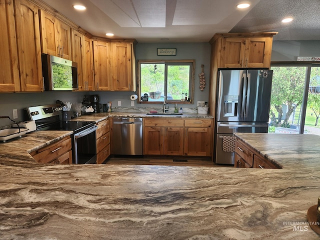 131 Beaver Nob Dr, Kamiah, ID 83536 - kitchen with stainless steel appliances, a sink, recessed lighting, healthy amount of natural light, and light stone counters