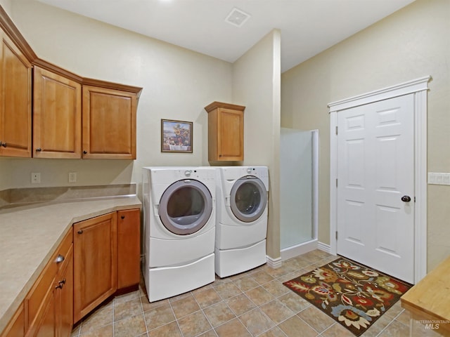16480 Goodson Rd, Caldwell, ID 83607 - laundry area with cabinets, light tile floors, and separate washer and dryer