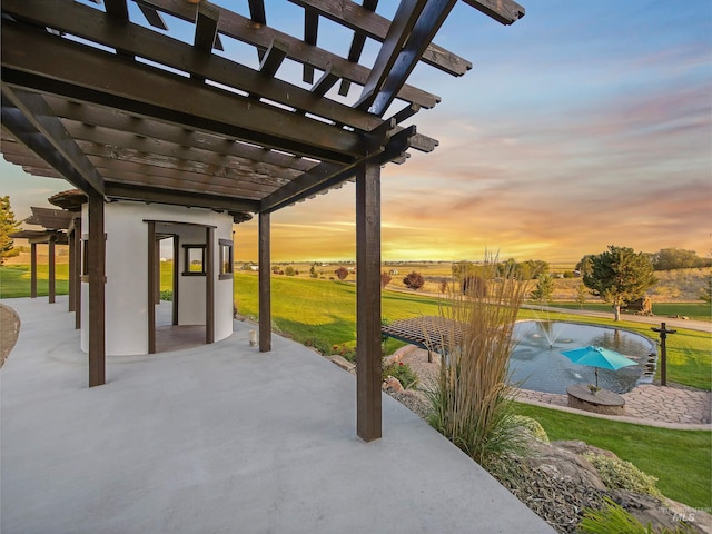 16480 Goodson Rd, Caldwell, ID 83607 - patio terrace at dusk with a swimming pool, a yard, and a pergola