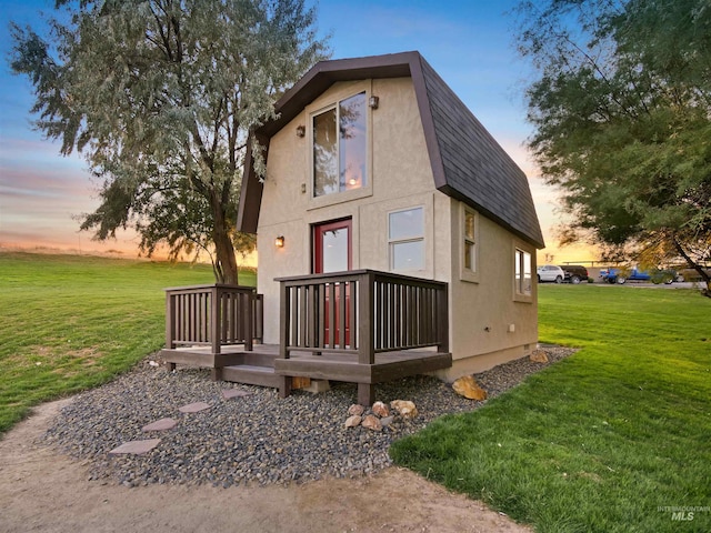 16480 Goodson Rd, Caldwell, ID 83607 - back house at dusk with a yard and a wooden deck