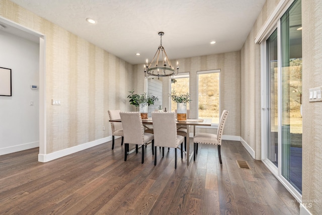 dining space featuring an inviting chandelier and dark hardwood / wood-style floors