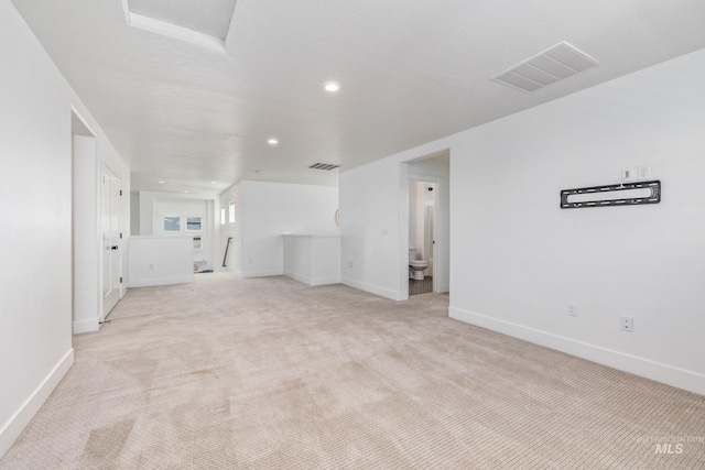 unfurnished living room with light colored carpet