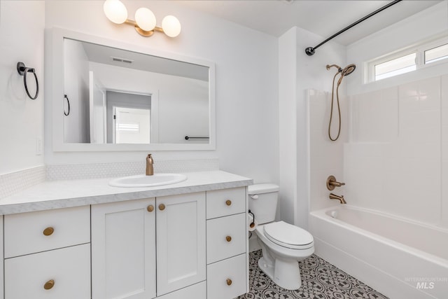 full bathroom featuring tub / shower combination, vanity, and toilet