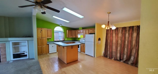 kitchen featuring a center island, decorative light fixtures, vaulted ceiling with skylight, light wood-style floors, and white appliances