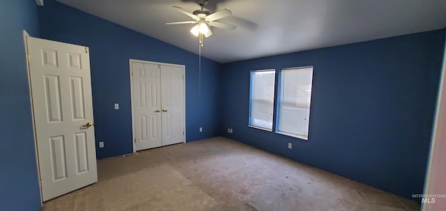 unfurnished bedroom with a closet, a ceiling fan, and lofted ceiling