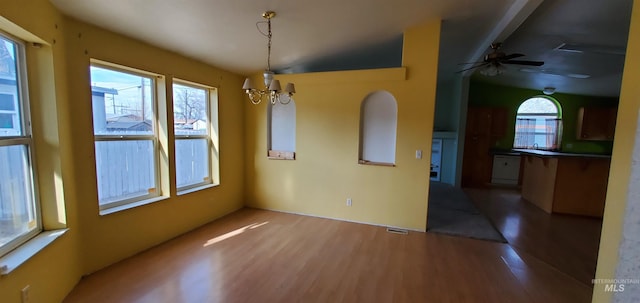 unfurnished dining area with a chandelier, visible vents, and wood finished floors