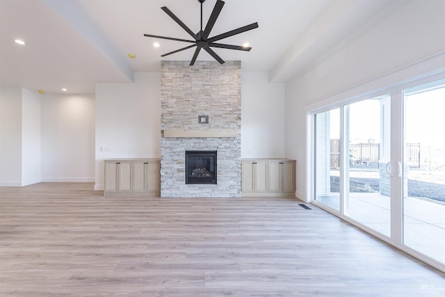 unfurnished living room with light wood-style floors, recessed lighting, a fireplace, and baseboards