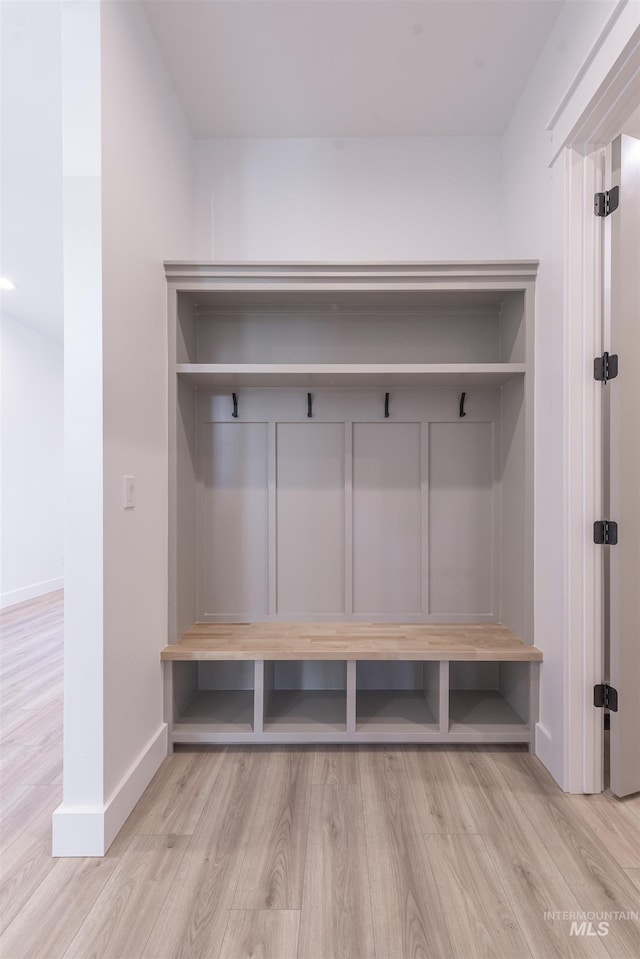 mudroom featuring baseboards and wood finished floors