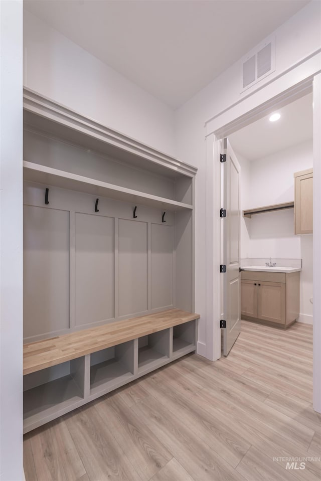 mudroom featuring visible vents and light wood finished floors