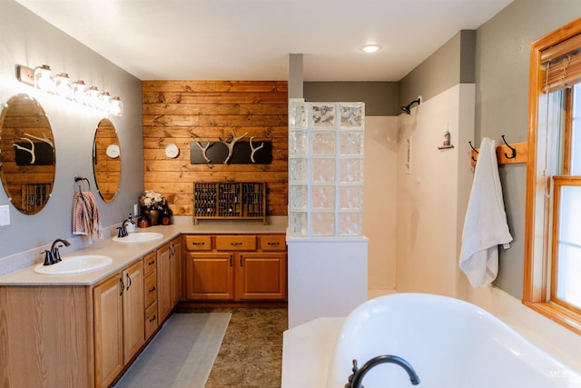 bathroom with a tub and vanity