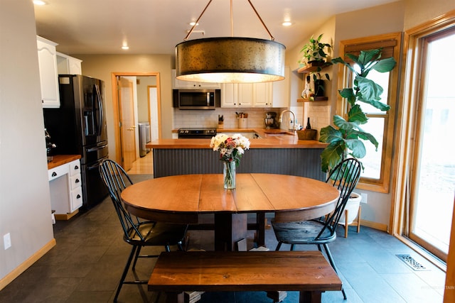 tiled dining area featuring sink