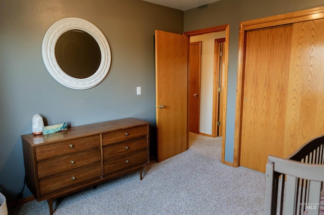 bedroom with light colored carpet and a crib