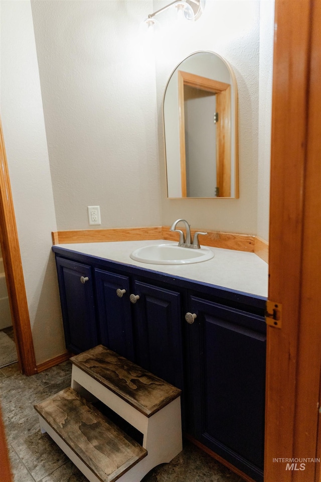 bathroom featuring tile patterned flooring and vanity