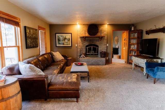 carpeted living room with a fireplace and a textured ceiling