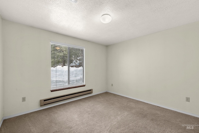 carpeted spare room with baseboards, baseboard heating, and a textured ceiling