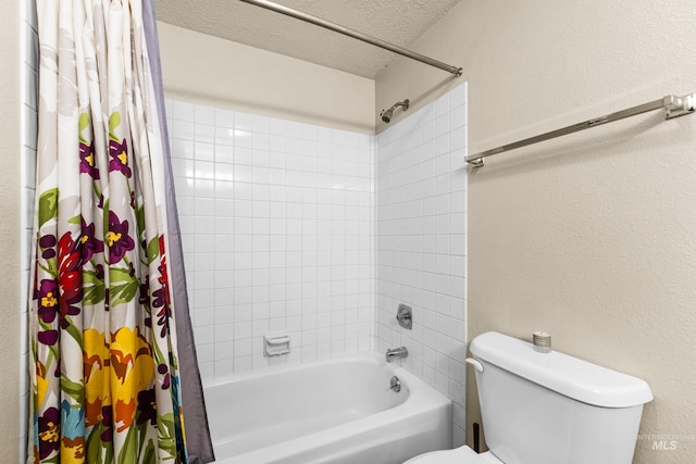 bathroom with a textured ceiling, a textured wall, shower / bath combination with curtain, and toilet