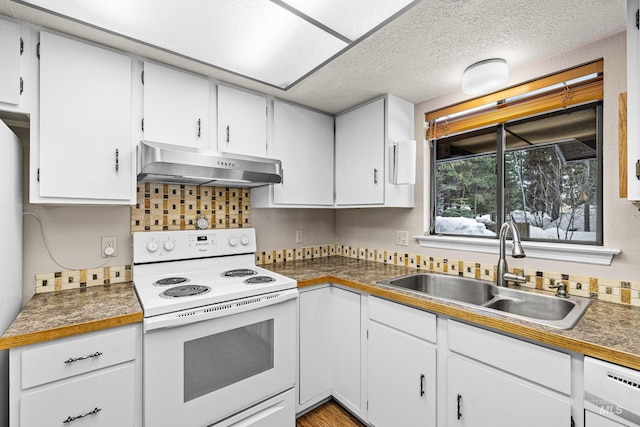 kitchen with wall chimney exhaust hood, a sink, white range with electric stovetop, and white cabinetry