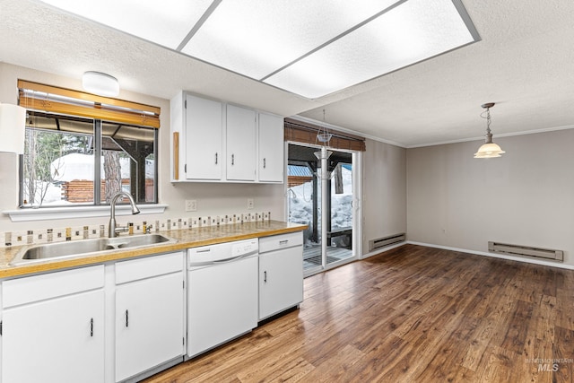 kitchen with light countertops, a baseboard heating unit, white dishwasher, a sink, and wood finished floors