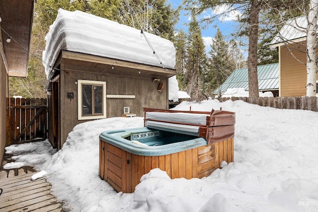 exterior space featuring fence and a hot tub