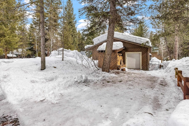 view of snowy exterior featuring an outdoor structure