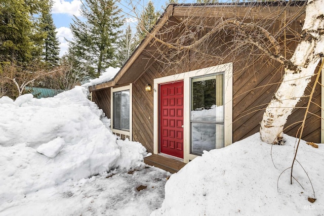 view of snow covered property entrance