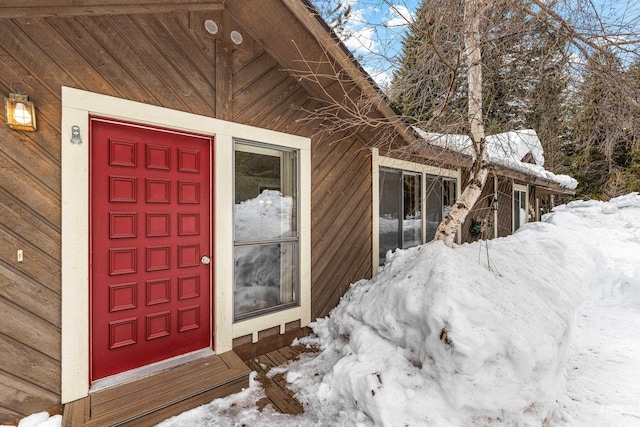 view of snow covered property entrance