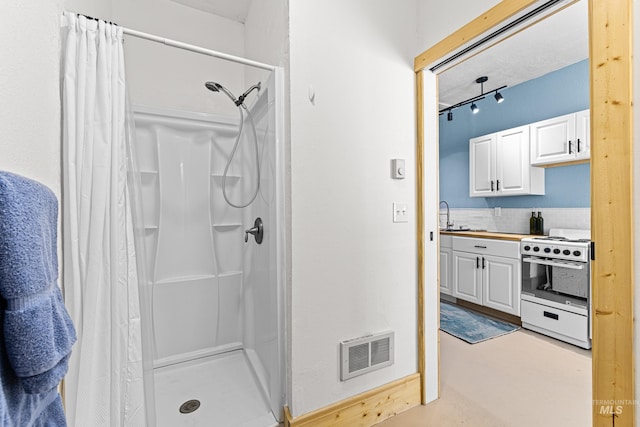 full bathroom featuring vanity, a shower stall, and visible vents