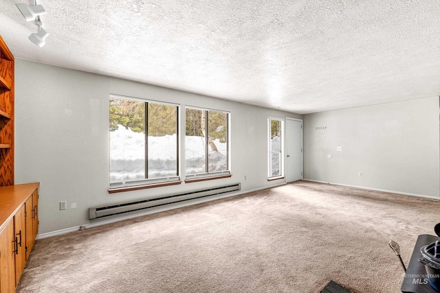 unfurnished living room featuring a baseboard radiator, carpet flooring, a textured ceiling, and baseboards