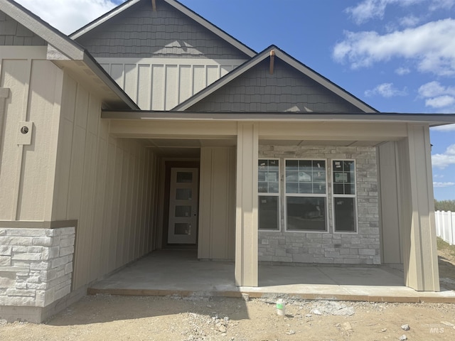 entrance to property featuring stone siding